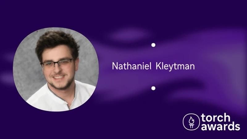 headshot of Nathaniel Kleytman on a variegated purple background and the torch awards logo in the lower right corner.