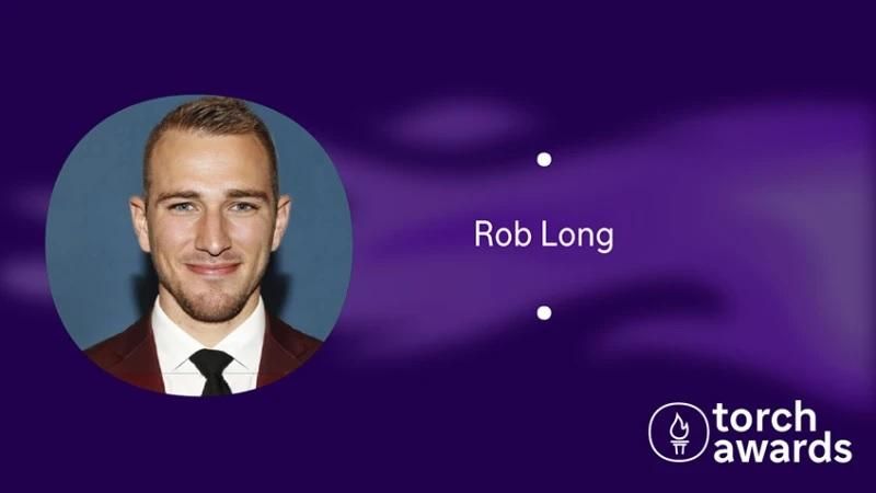 headshot of Rob Long on a variegated purple background and the torch awards logo in the lower right corner.