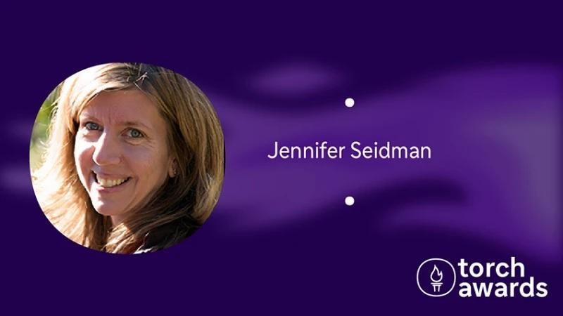 headshot of Jennifer Seidman on a variegated purple background and the torch awards logo in the lower right corner.
