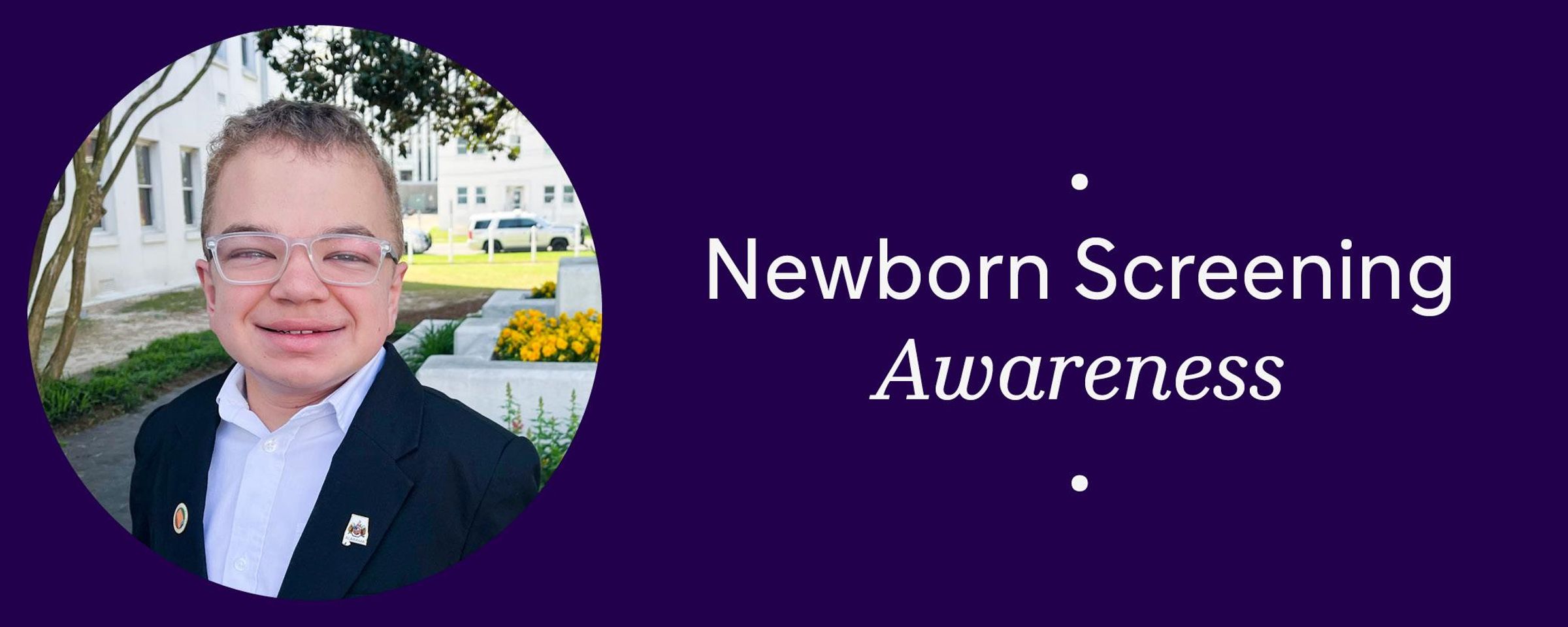 Zachary Thomas is shown wearing a dark blue blazer and a white shirt.