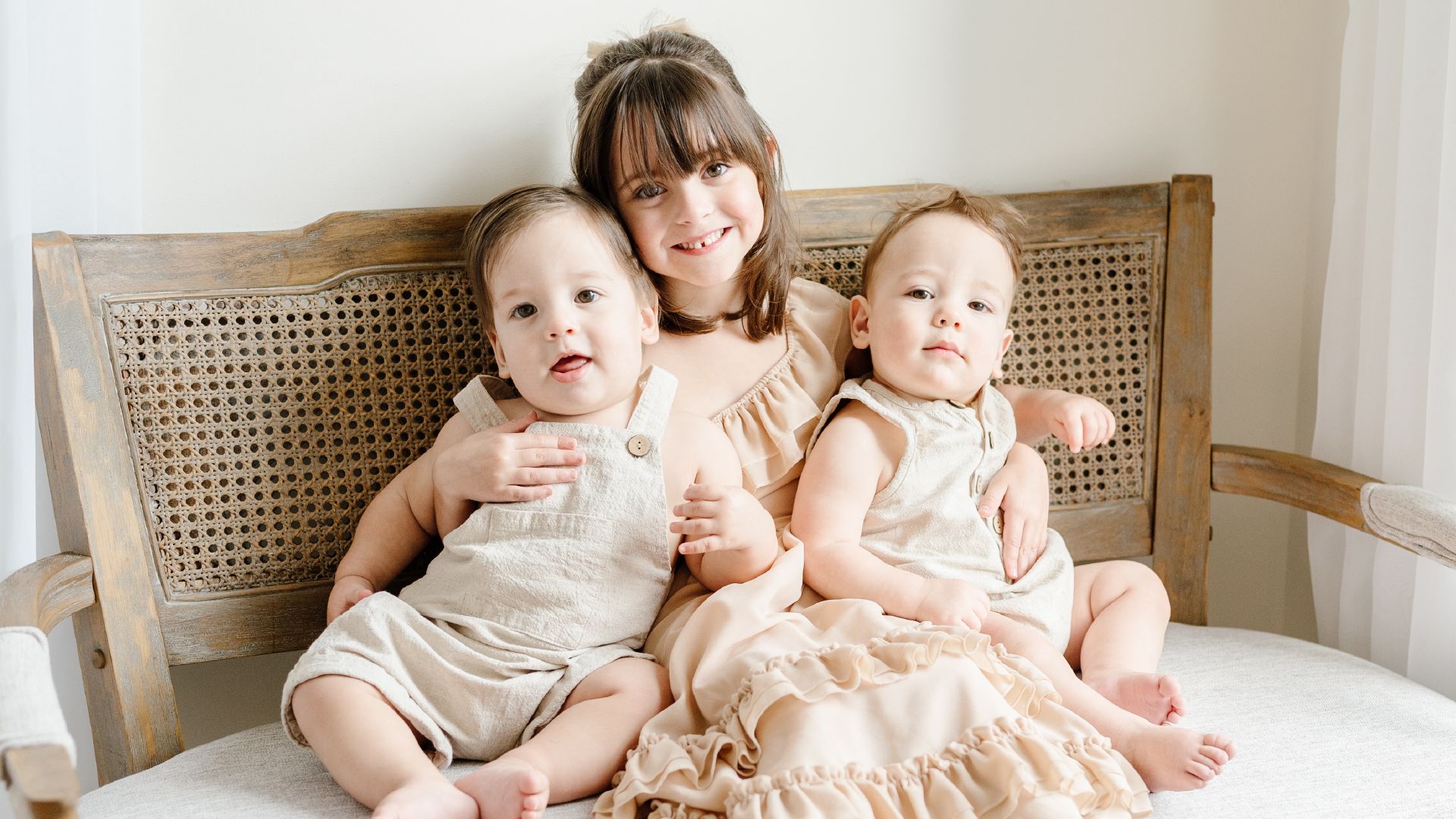 three children smiling together