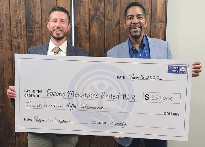 Phillip and Michael Tukeva, United Way President, hold a large check between them for $250,000 made out to Pocono Mountains United Way.