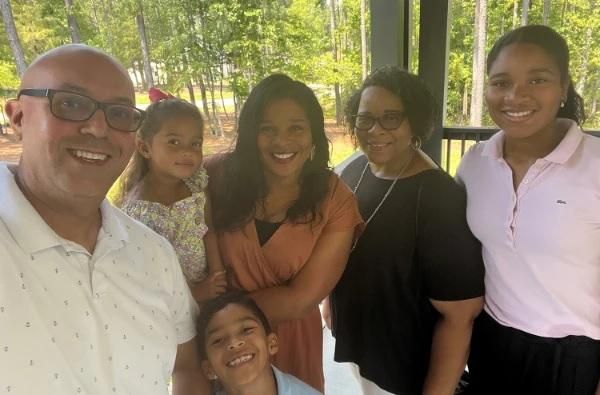 Dr. Ayanna Santos stands with her whole family.