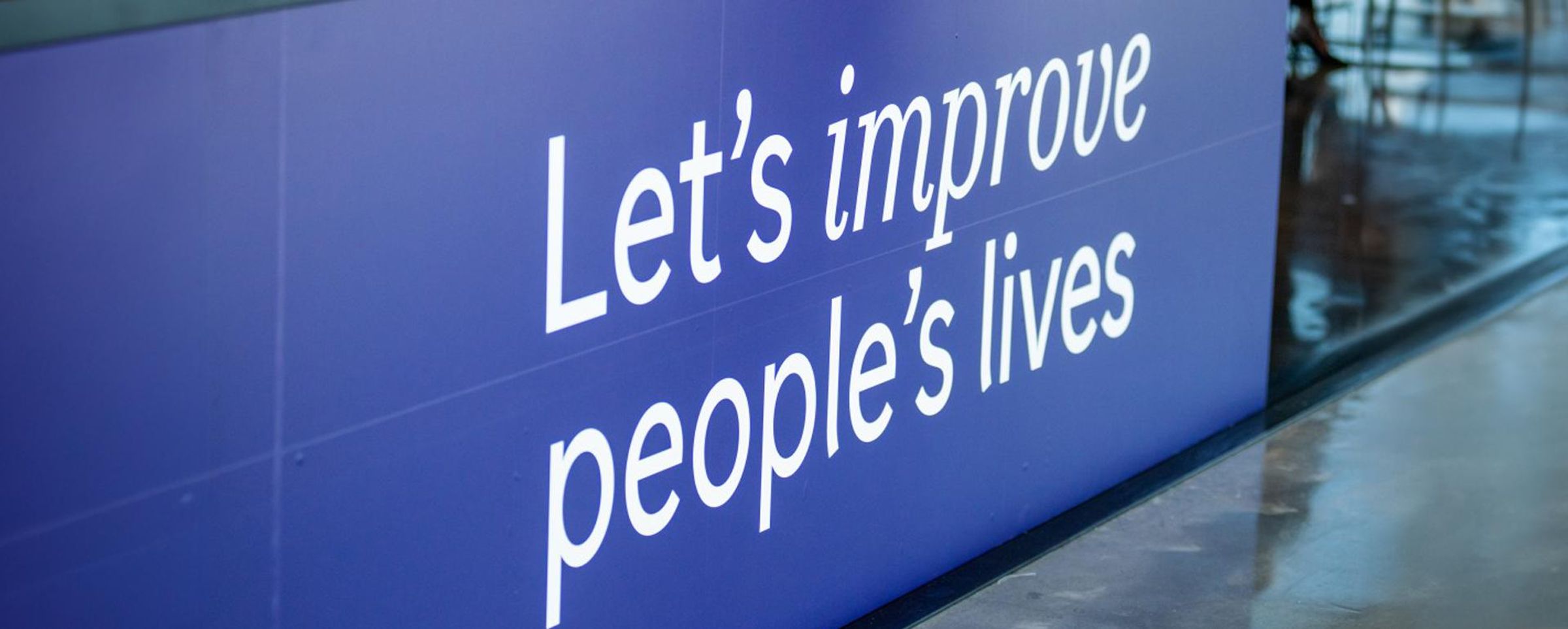 Blue banner with Sanofi tagline saying, "Let's improve people's lives".