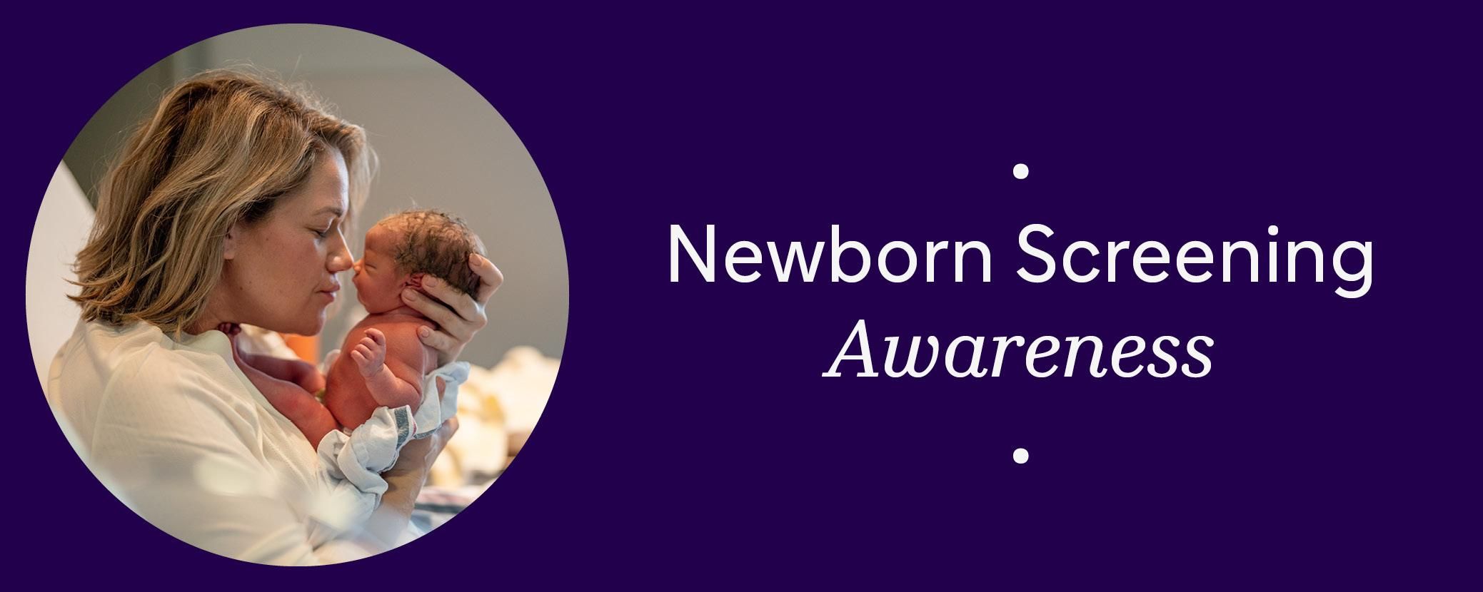 A woman holding a newborn child