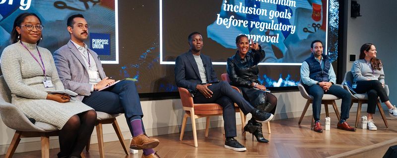 The Art of Dialogue panel participants led by Lewis Iwu and Tanisha Sullivan at the 2025 TIE Summit sitting on stage as they listen to questions from the crowd.