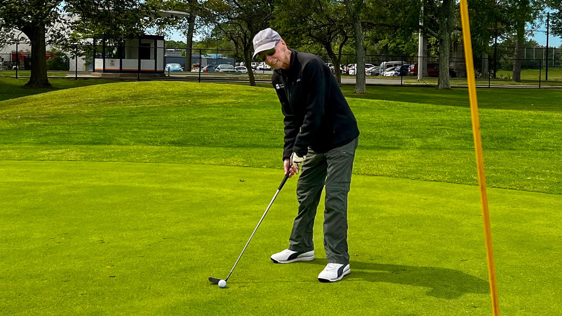 Lew putting on a golf course.