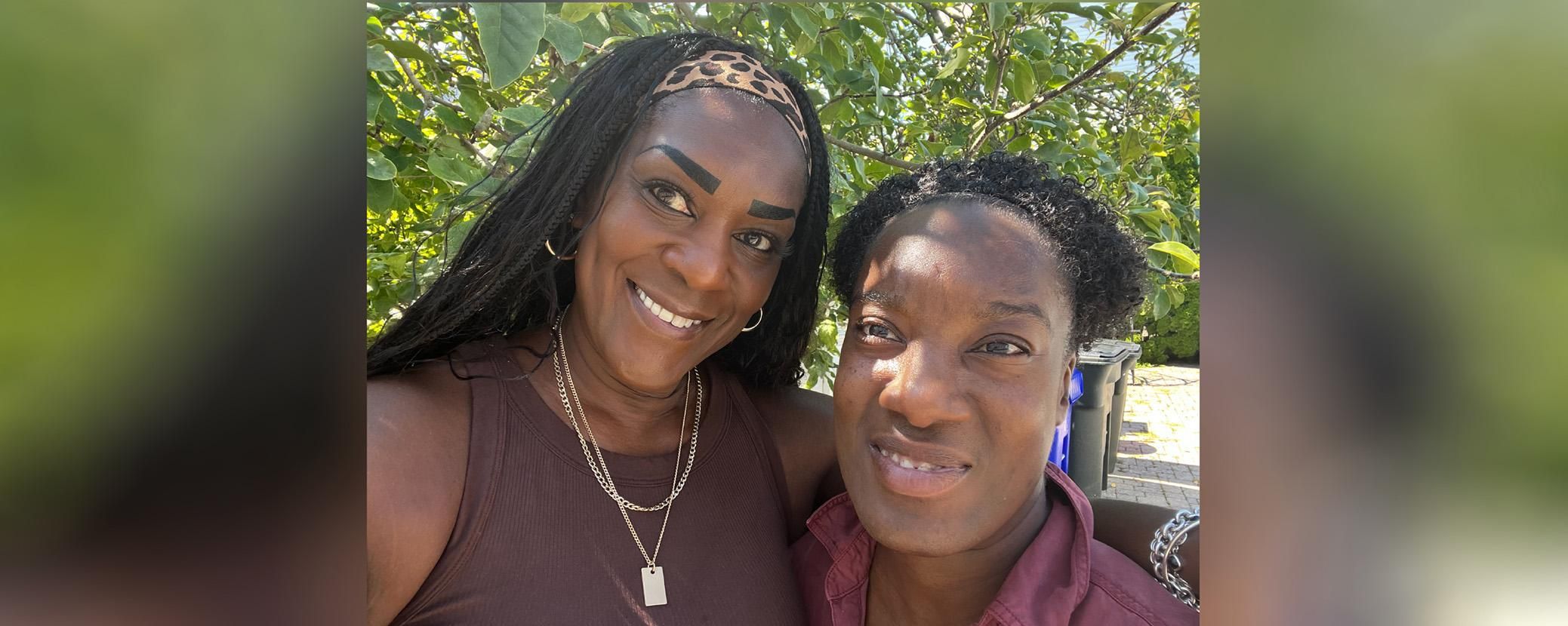 Stacy and her daughter are close together side by side and smiling