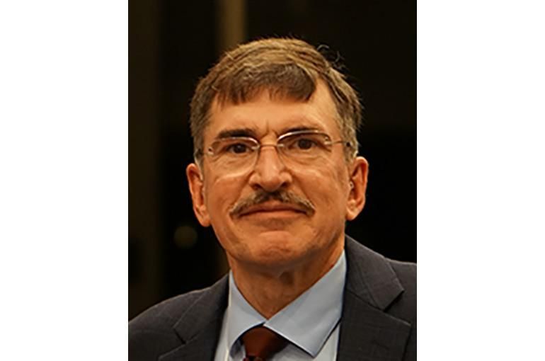 Headshot of jack johnson in a suit smiling at the camera.