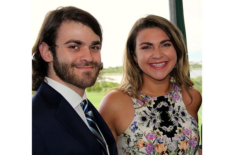 Leland and Taylor Smith as adults smile at the camera.
