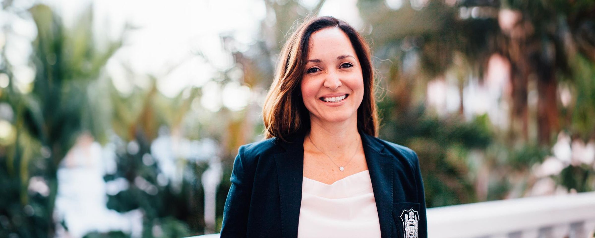 Veronica Martinez smiles at the camera in an outdoor headshot.