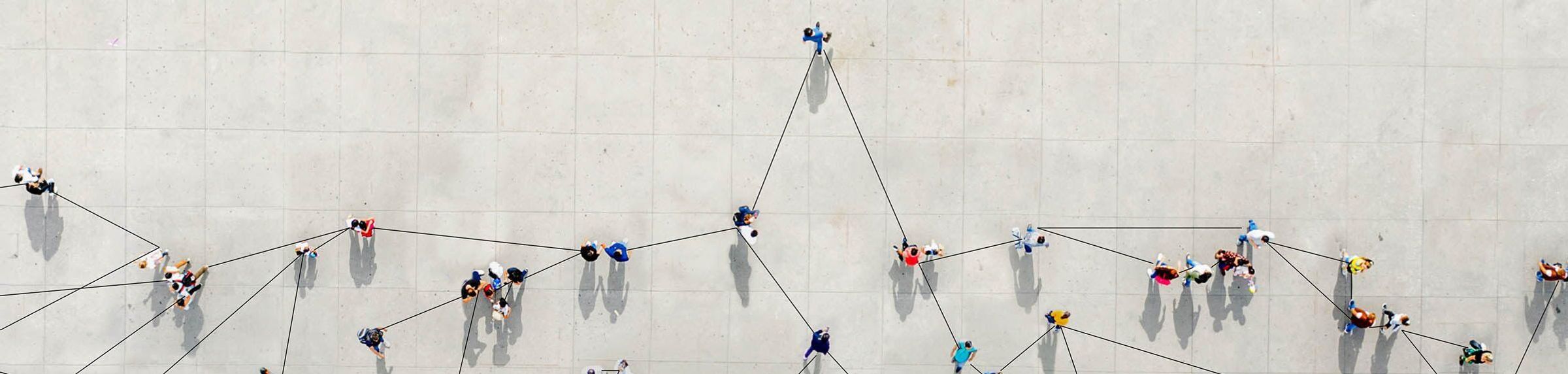 A stock image showing an aeriel view of multiple people connected by black lines.
