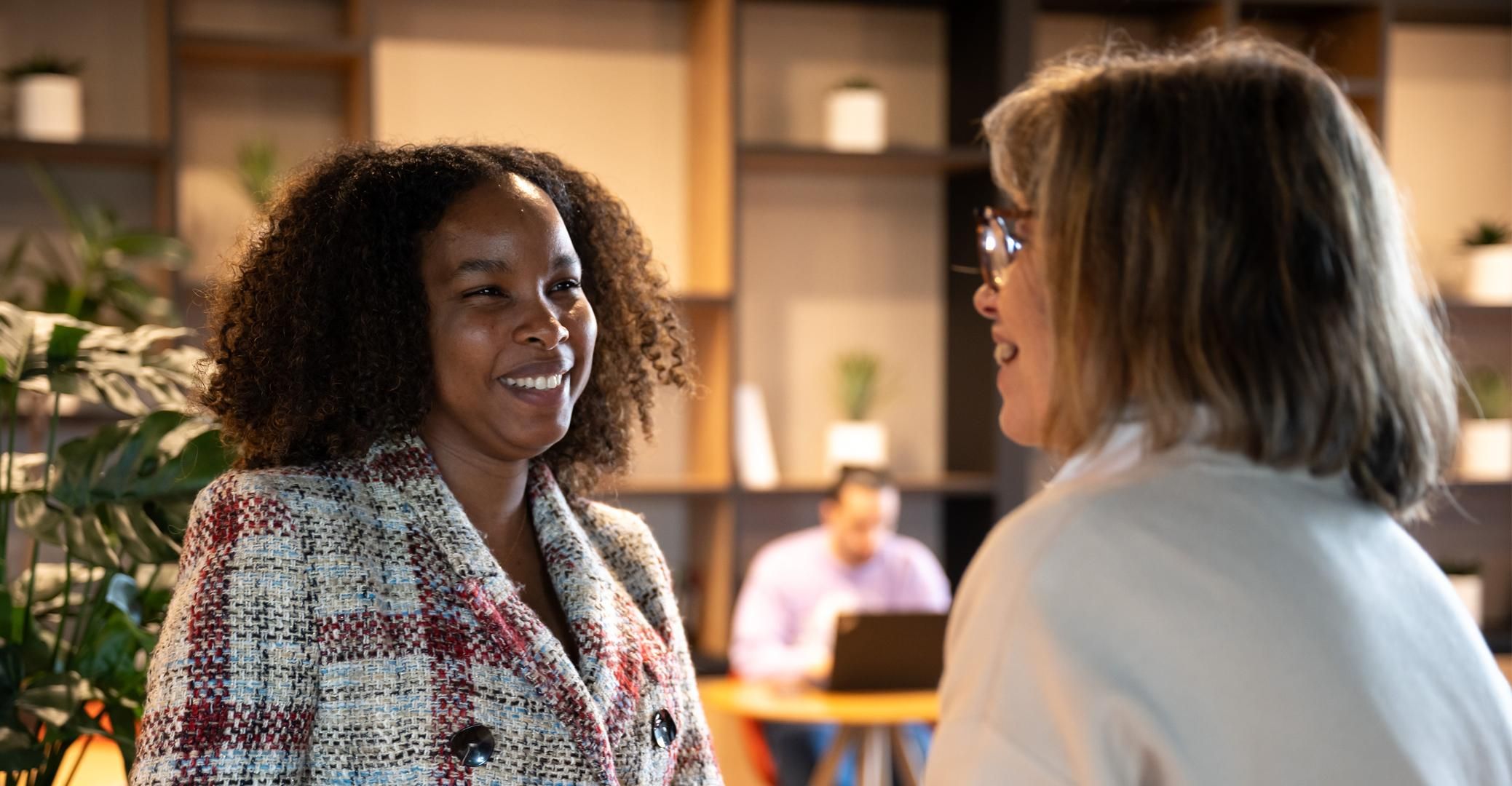 Ilyassou Sow and Sylvie Girard laugh and smile as they speak to one another